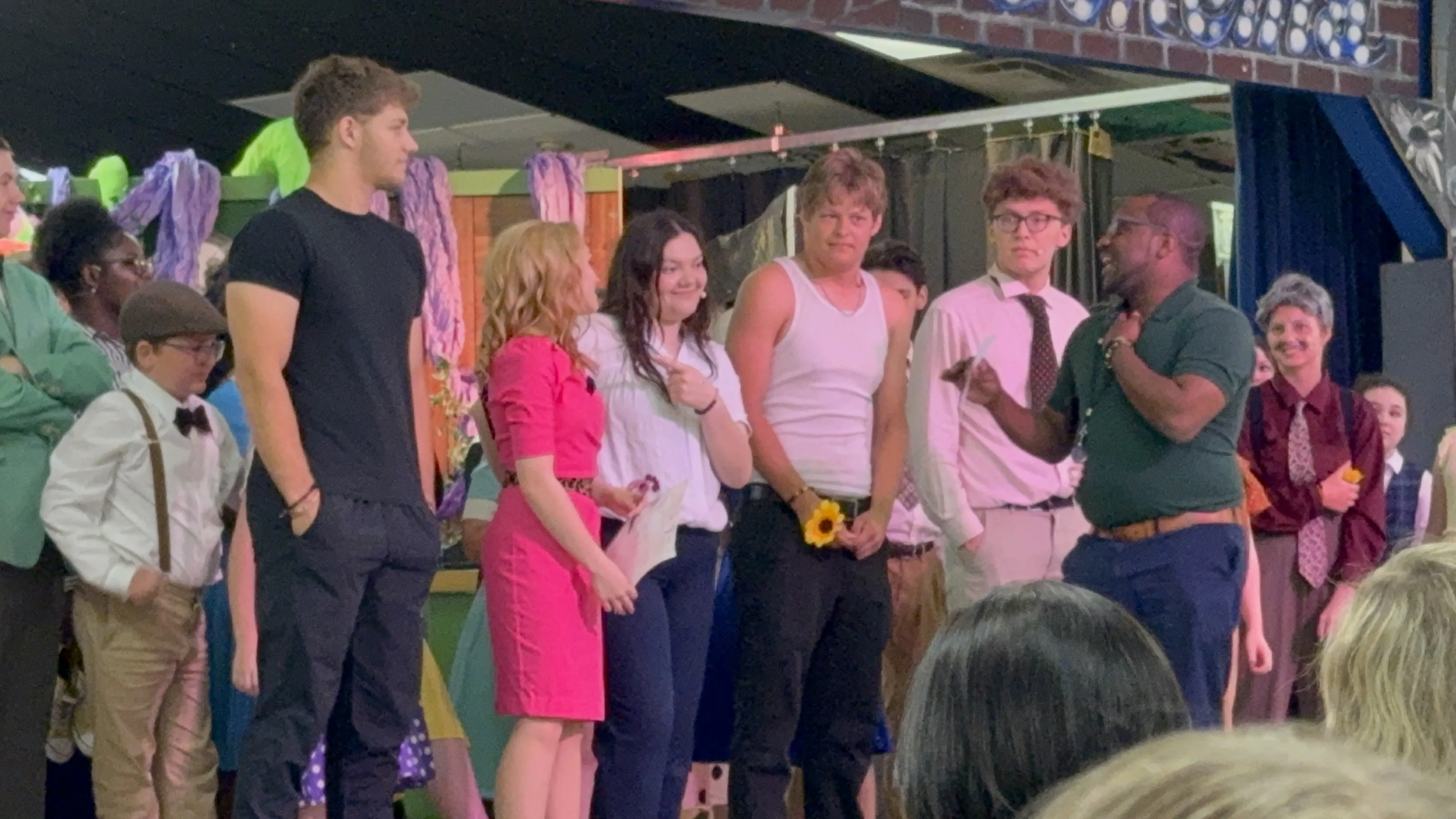 Full ensemble cast on stage with Jason Wright