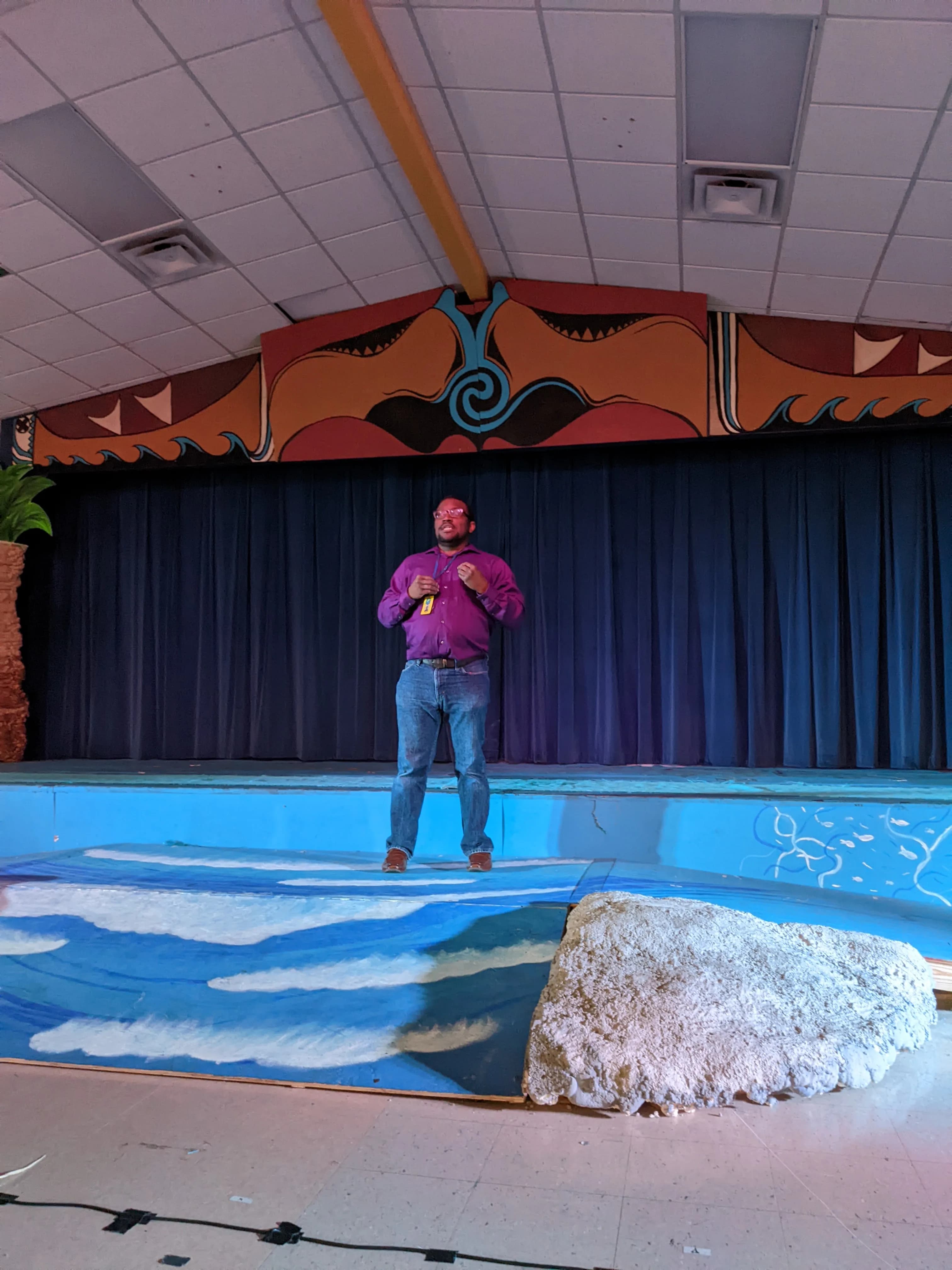 Jason Wright standing alone on stage during a Moana production