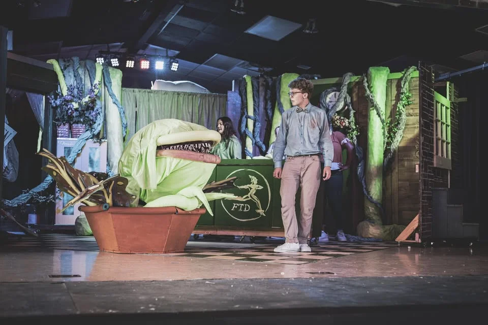 Little Shop of Horrors full ensemble on stage, Piedmont City Schools Theater